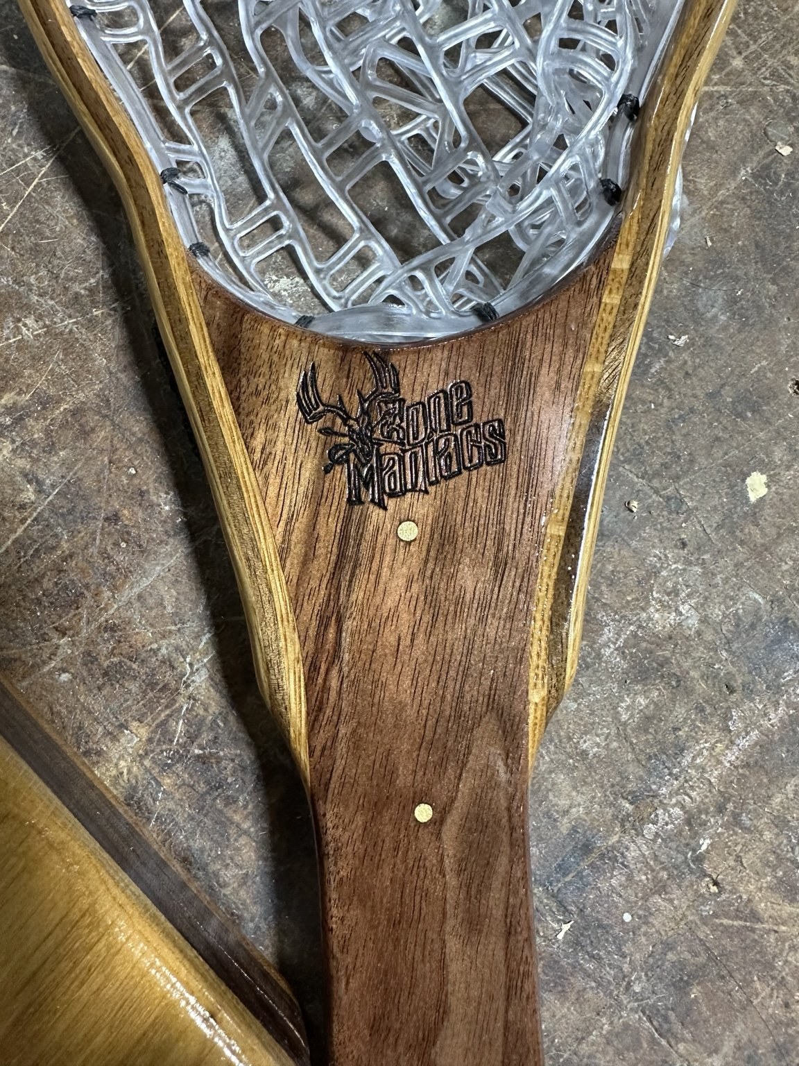 Bone Maniacs club logo engraved on a net handle