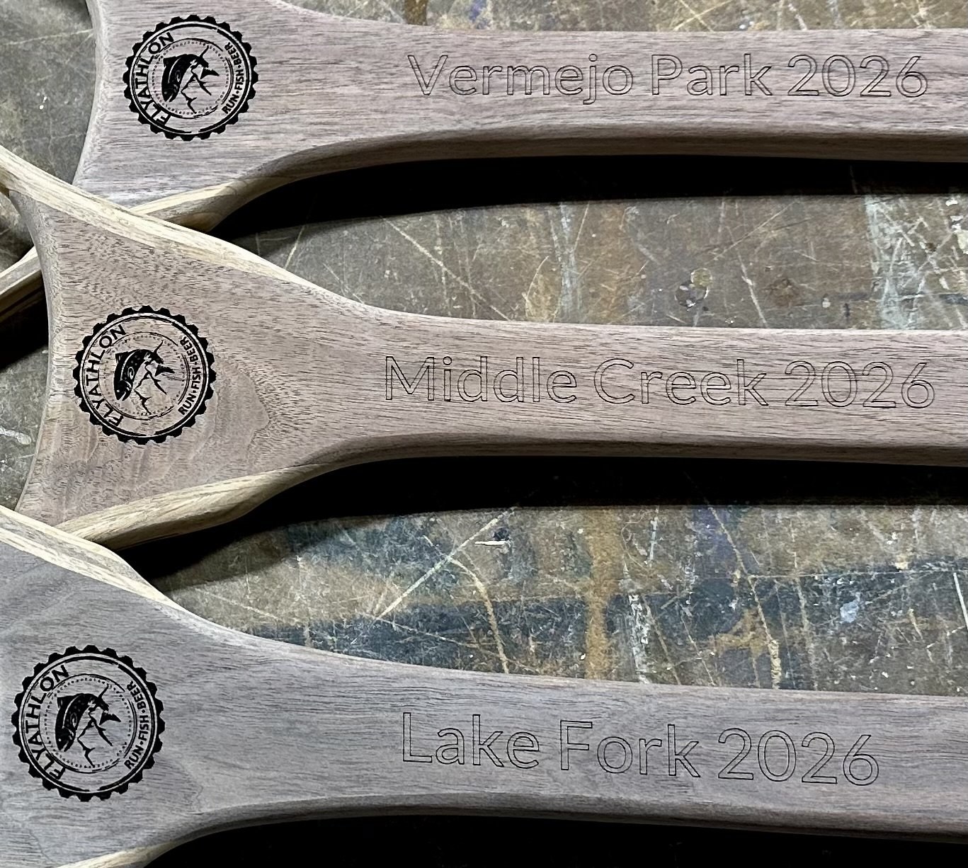 Net handles engraved with water names and the year
